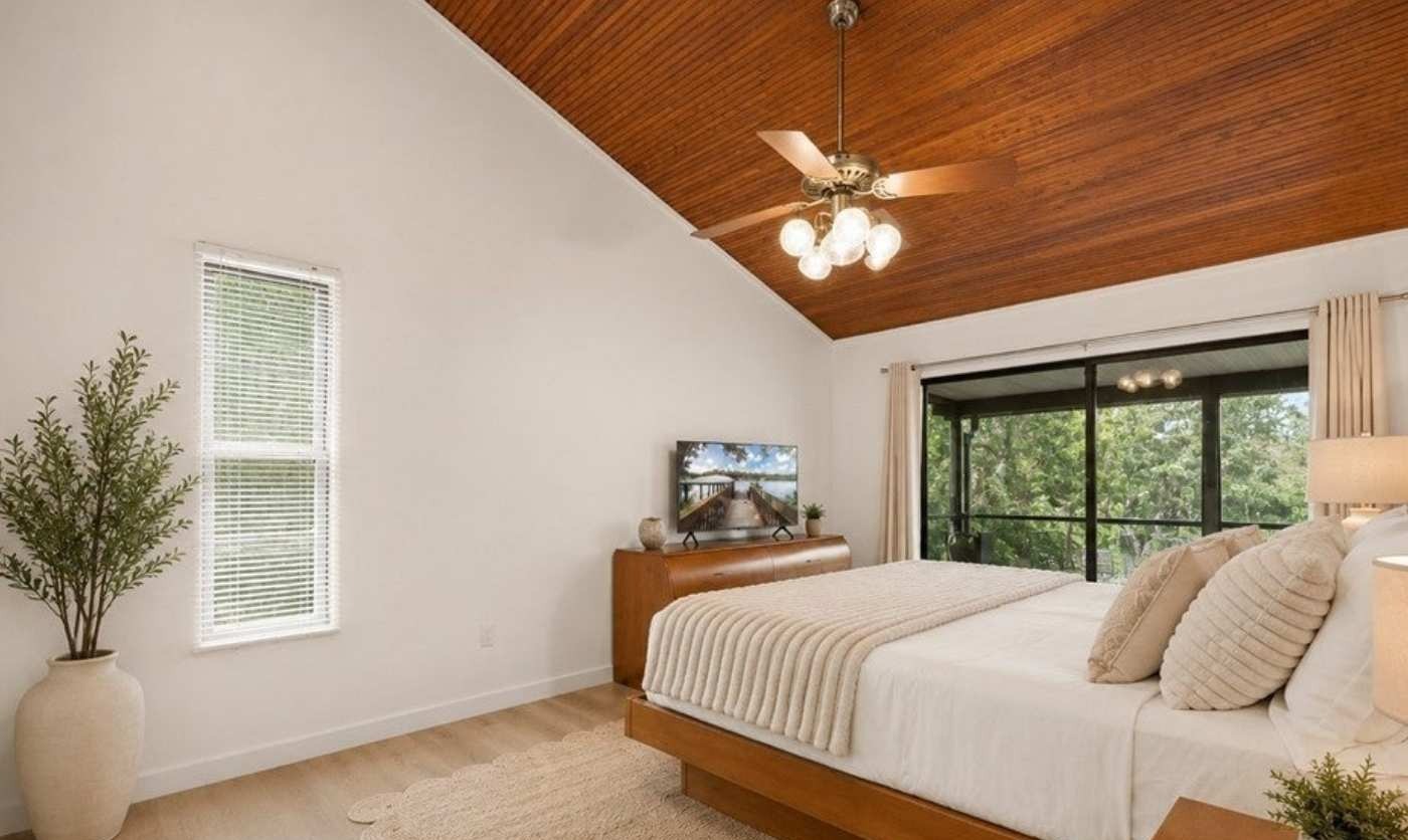 Bedroom with vaulted wood ceiling and soft natural light