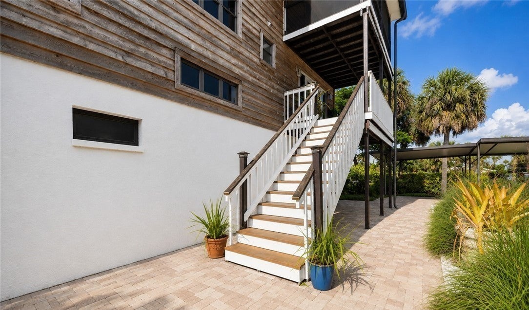Weathered wood exterior siding and stairway beside the home