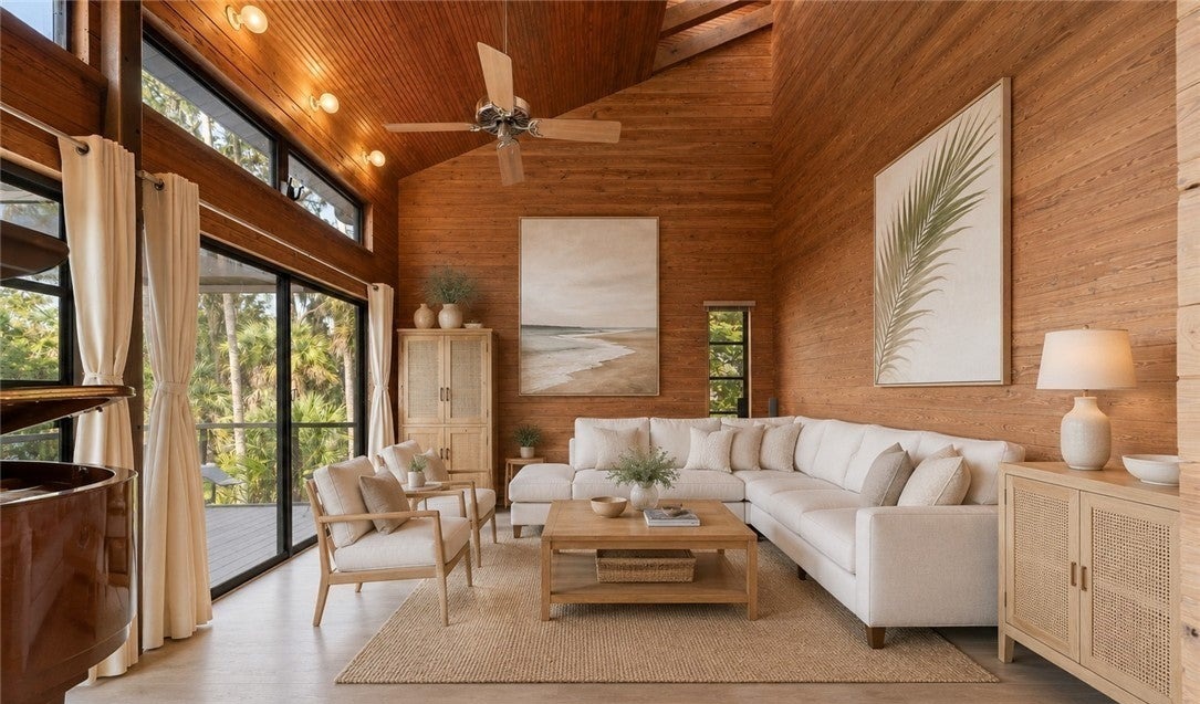 Living room showing wood walls and ceiling with expansive windows