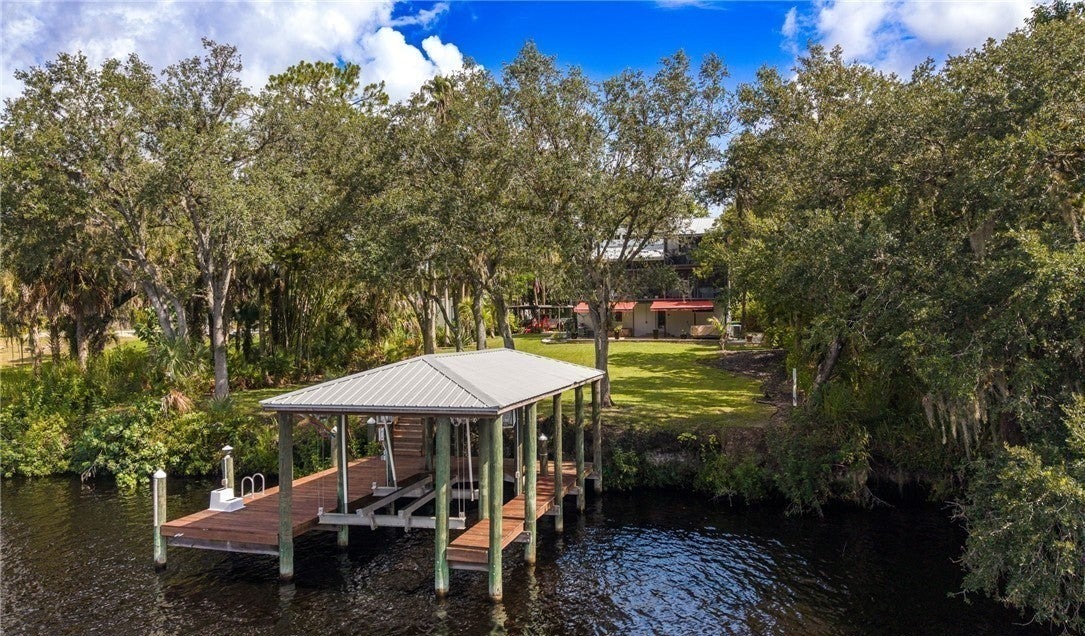 Aerial view of the covered boathouse and dock at the riverfront home