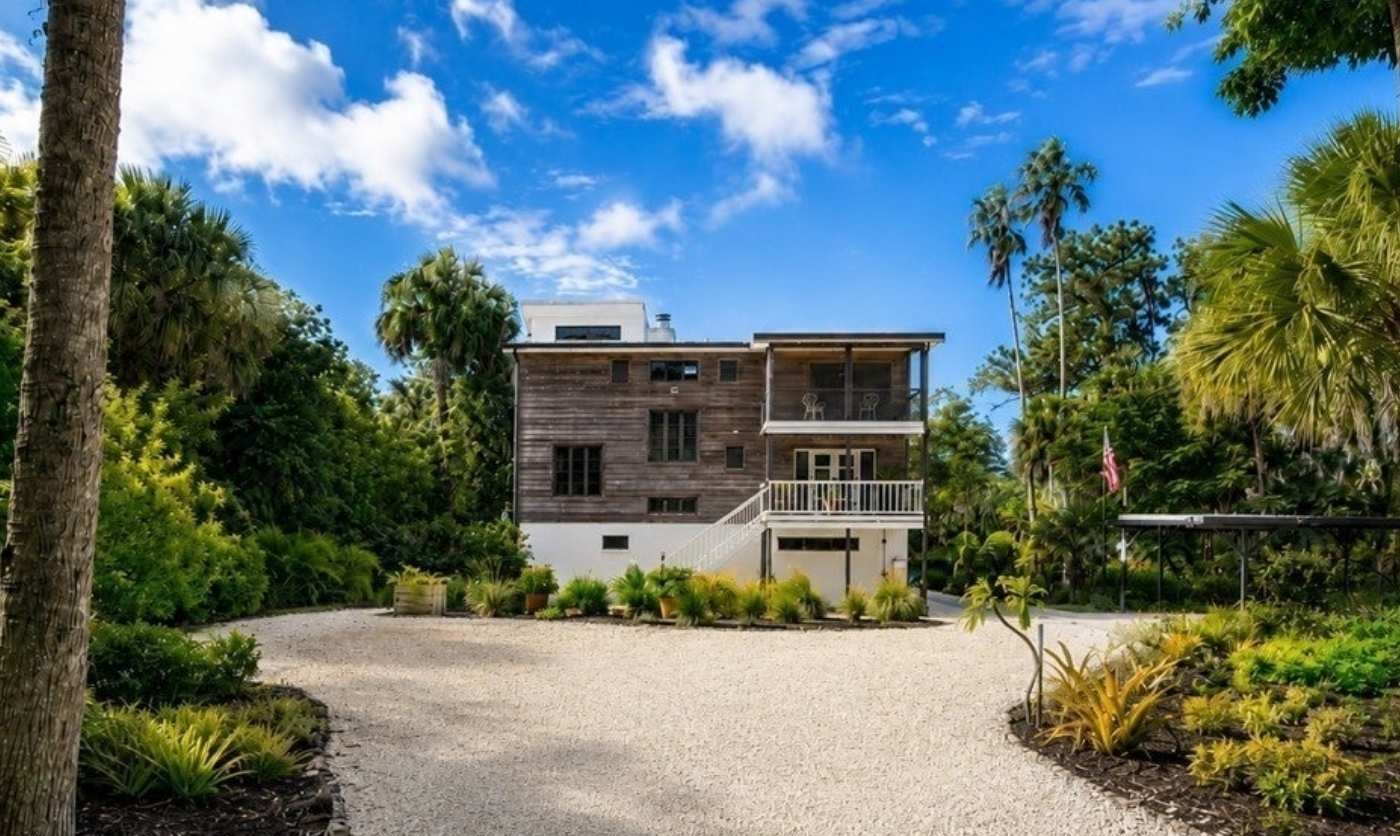 Landscaped approach with palms and lush greenery